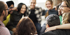 people with their arms around each other smile because of their experiences at gay addiction treatment centers in Florida